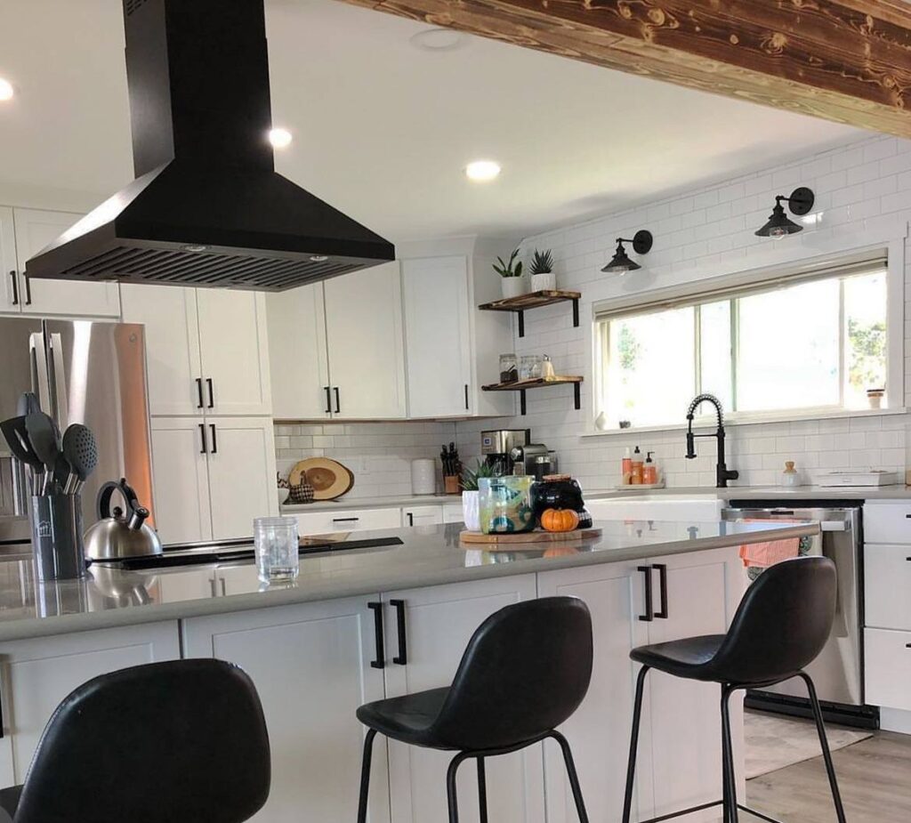 Kitchen remodel with white cabinets, black island stools, quartz counters, floating shelves and black range hood in Kitsap County, WA
