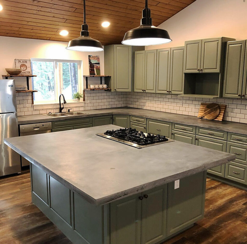 Kitchen remodel with sage green cabinets, large island cooktop, subway tile backsplash and cedar plank ceiling in Kitsap County, WA